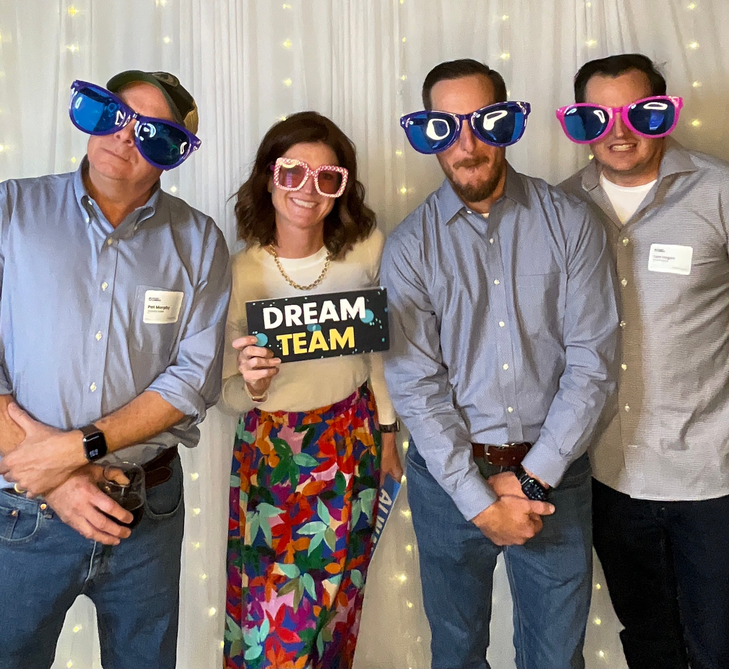 Guests having fun with colorful props at photo booth party